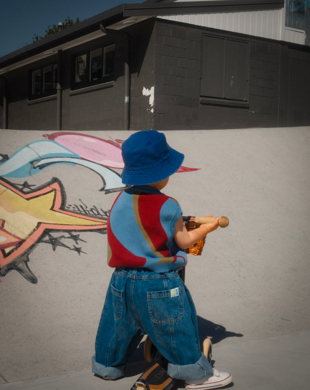 Toddler wearing wide leg barrel-leg blue jeans with rolled hem — From Y To Z