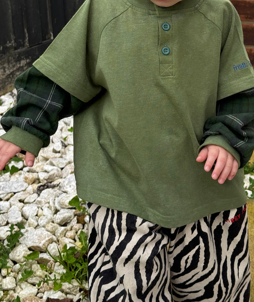 Child wearing ollie double-sleeve in hunter