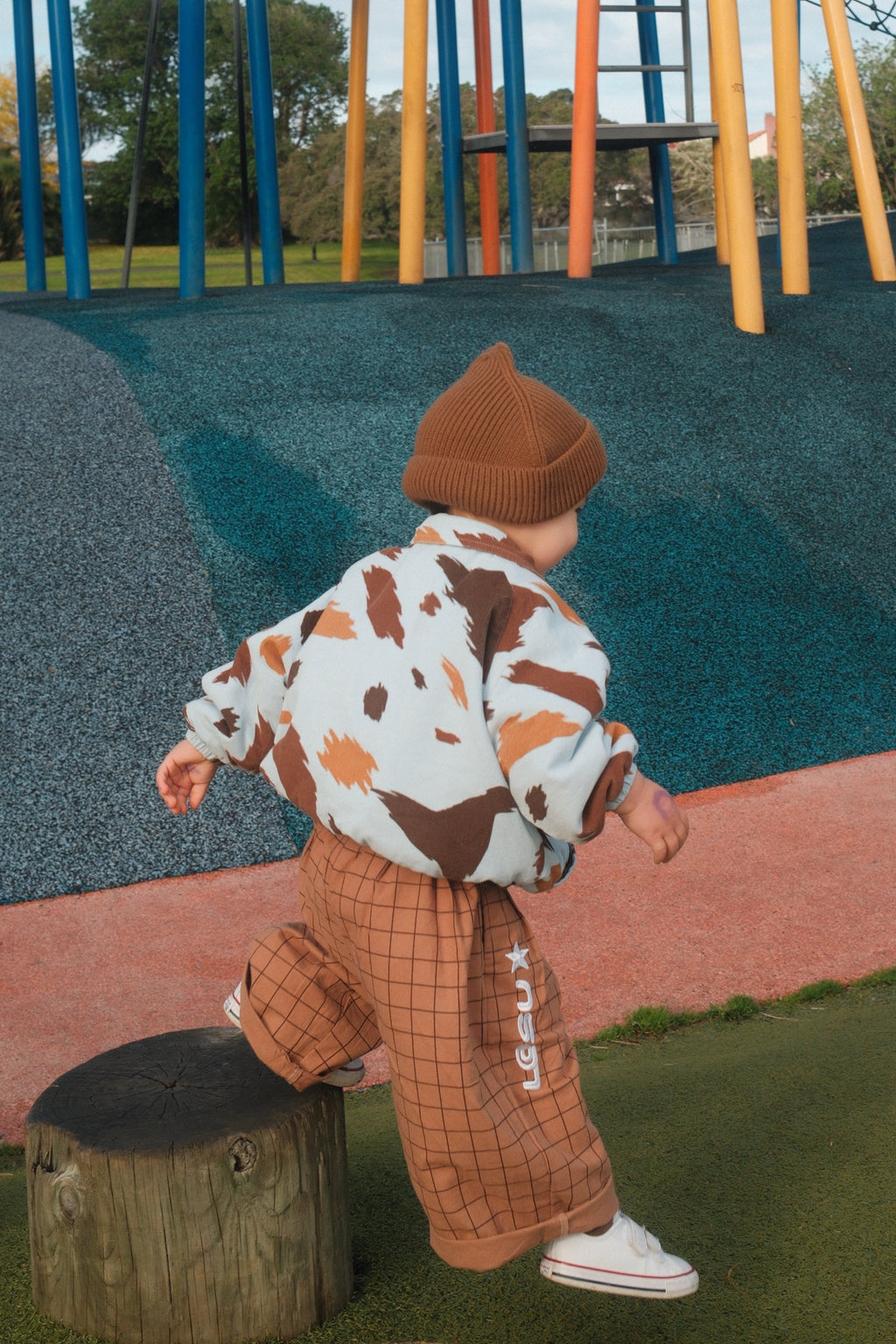 Toddler in playground wearing Seffi jacket in milkyway custom cow-print corduroy fleece 